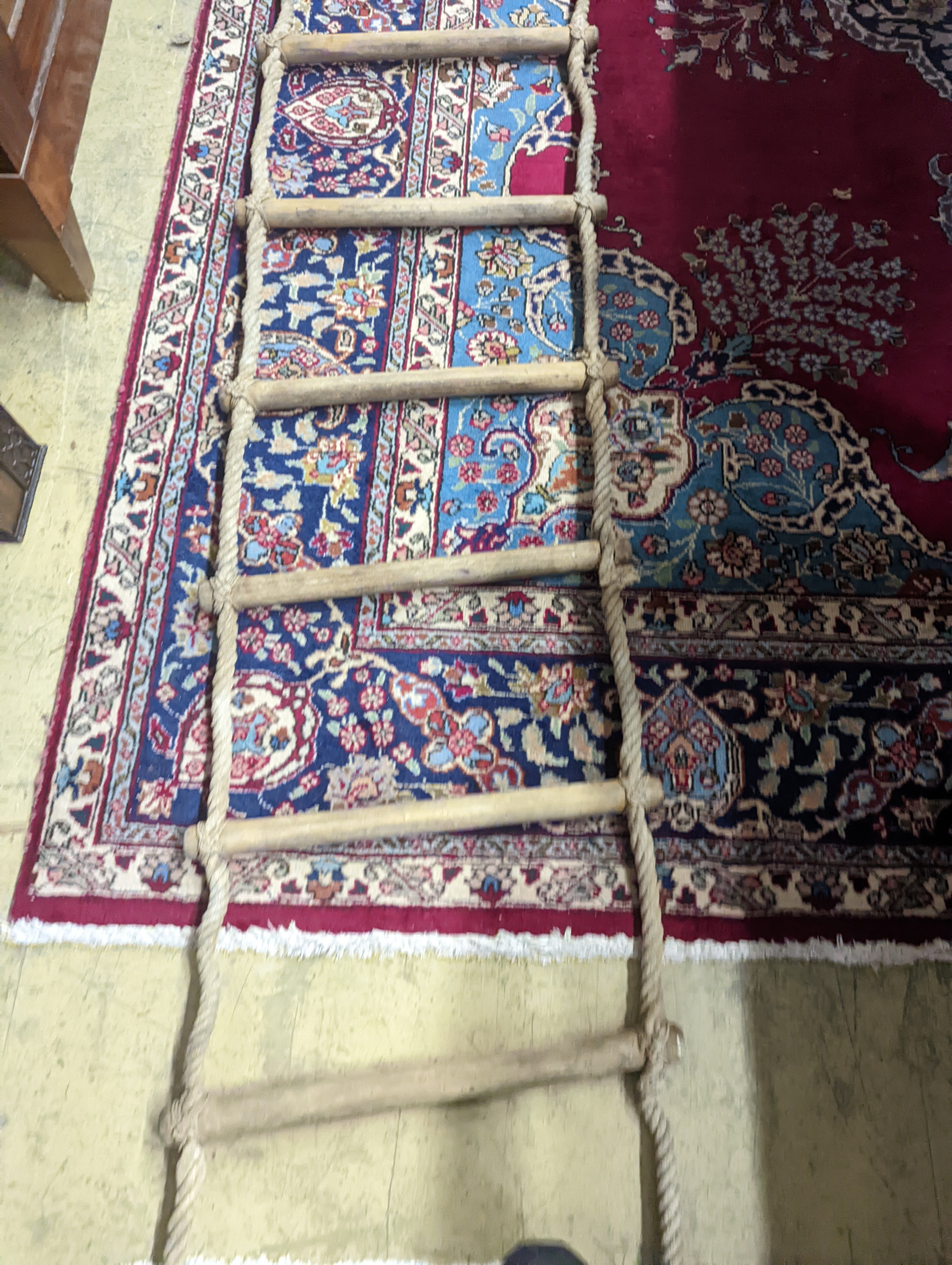 A rope ladder, Length 3.9 meters. (1 lower rung damaged)
